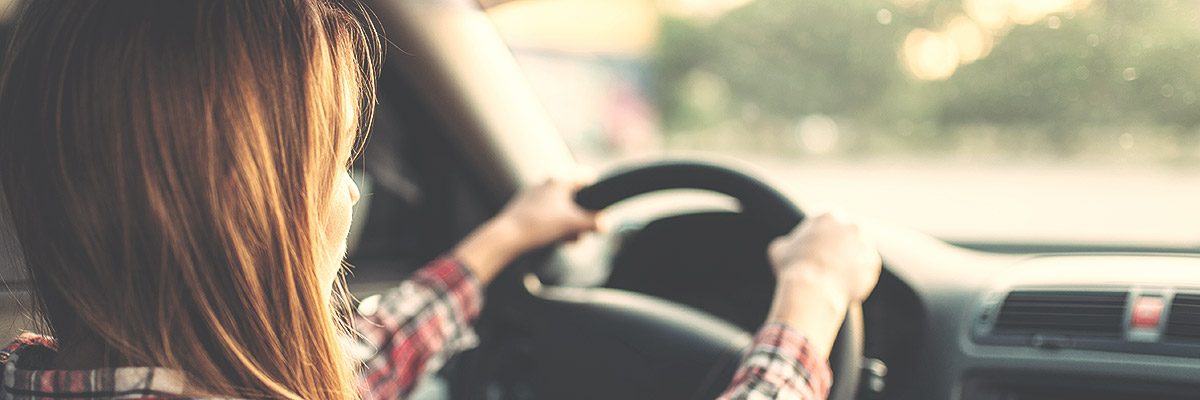 girl holding steering wheel