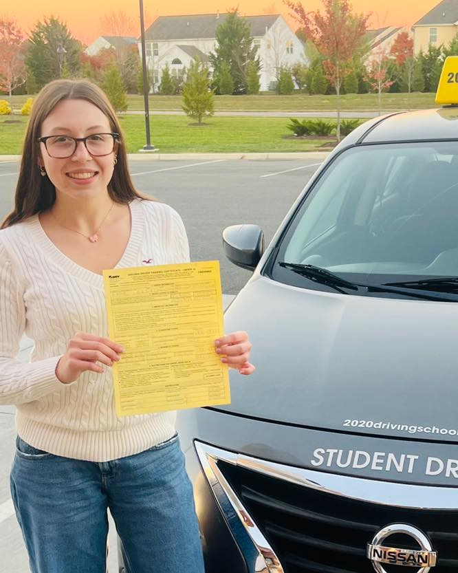 Proud graduate with a certificate at 2020 Driving School